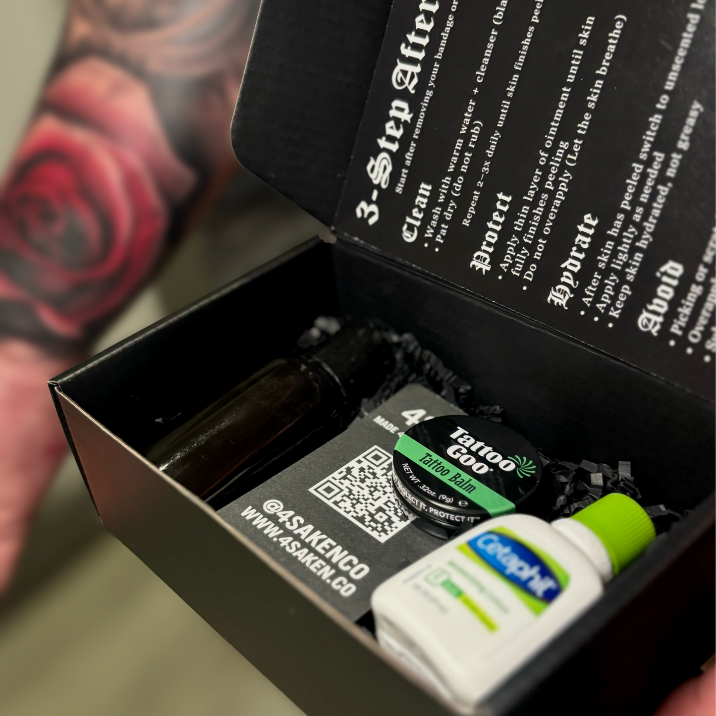Tattoo aftercare kit with products and instructions in a black box.